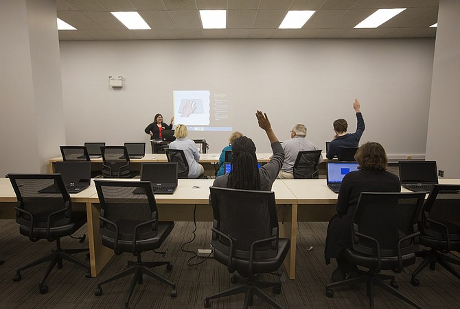 Eudora Welty Library staff members sit in the new Technology Learning Lab, which will be home to free computer and tech courses offered all year long.