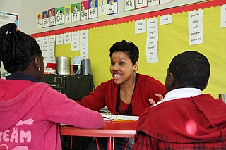 In this 2014 photo, literacy coach Kristen Wells works with students at Emmalee Isable Elementary in west Jackson. Literacy coaches are used statewide to help teachers teach literacy and boost reading scores. Photo courtesy Jackie Mader/The Hechinger Report