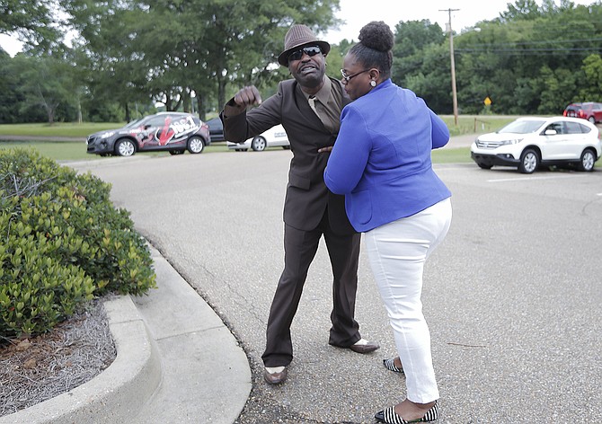 An unidentified woman took away Byron McBride Sr. as he screamed and cried, saying that his son Byron McBride Jr. did not kill Kingston Frazier.  
