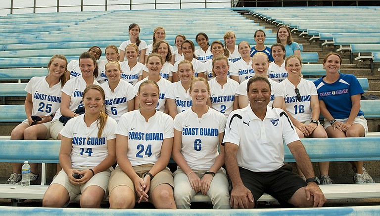 Coach Tony DiCicco of the Boston Breakers Professional Women's Soccer Team sits for a photo Saturday, Aug. 21, 2010, with the women's soccer team from the U.S. Coast Guard Academy at Veteran's Stadium in New Britain, Conn. Photo courtesy Flickr/US Coast Guard Academy