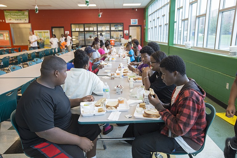 Children eat lunch at Blackburn Elementary School on June 23. The JPS Food Service Program provides the children with free meals.