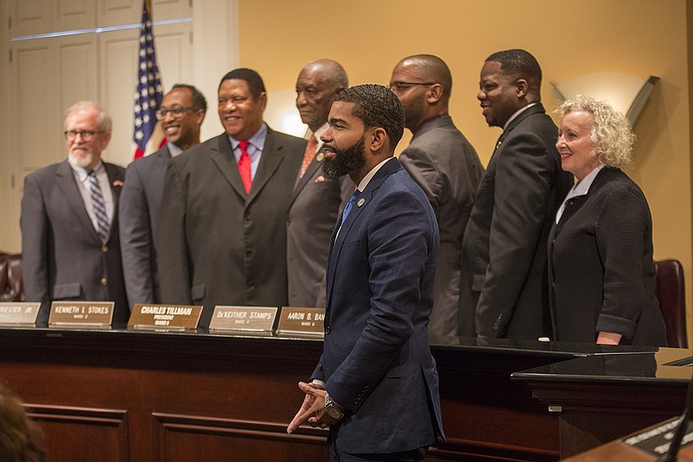 Mayor Chokwe Lumumba stands with the city council members after Charles Tillman and Melvin Priester, Jr. are named president and vice president.