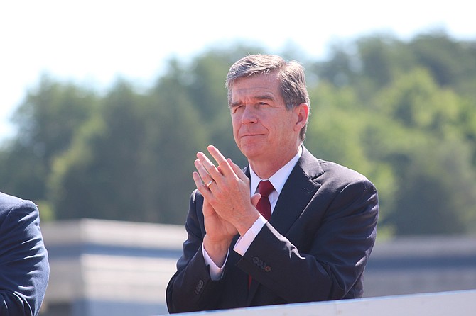 The compromise between Republican legislative leaders and Democrats led by Gov. Roy Cooper (pictured) eliminated a provision that required transgender people to use restrooms in many public buildings corresponding to the sex on their birth certificates. Photo courtesy Flickr/NCDOTcommunications