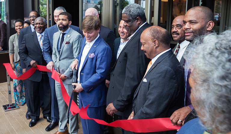 City, county and state leaders helped Joseph Simpson (center) cut the ribbon outside the new Westin Hotel in downtown Jackson on South Congress Street.
