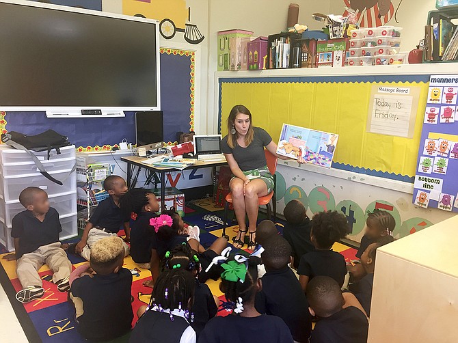 North Jackson Rotary Club Member and “Between the Lions” coordinator Jenny Price (back) reads to kids at Walton Elementary School for the project. Photo courtesy Clinton Smith