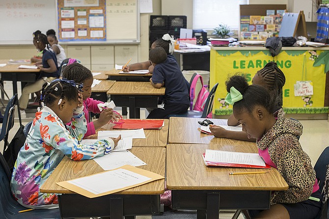 Children read during Operation Shoestring’s afterschool programming, which the organization calls Project Rise.