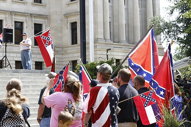 Mississippians supporting the state flag rallied outside the Capitol a month after Dylann Roof, a white supremacist, murdered nine African Americans in South Carolina. Investigators found pictures of him holding a rebel flag.