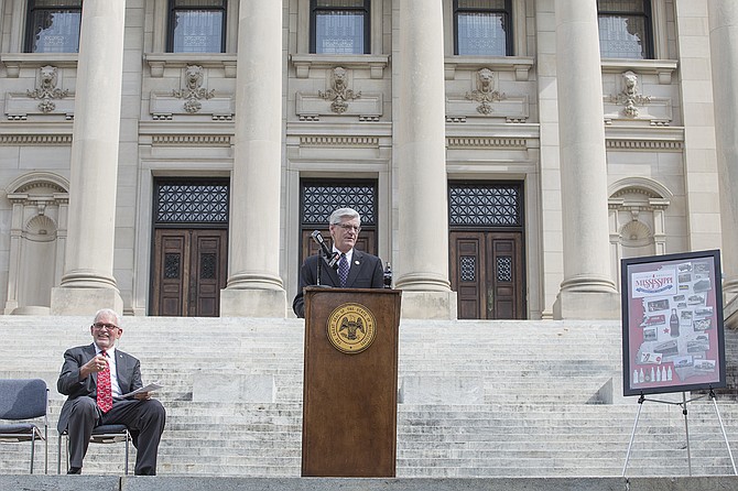 Gov. Phil Bryant and Albert Clark (left), president of Clark Beverage Group, announced the launch of an 8-ounce bicentennial Coca-Cola bottle at the Capitol Wednesday. Bryant also told reporters his office will not rush the takeover decision of Jackson Public Schools.