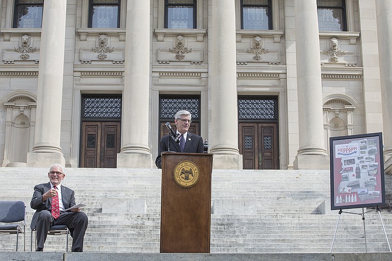 Gov. Phil Bryant and Albert Clark (left), president of Clark Beverage Group, announced the launch of an 8-ounce bicentennial Coca-Cola bottle at the Capitol Wednesday. Bryant also told reporters his office will not rush the takeover decision of Jackson Public Schools.