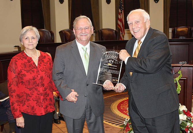 Former Mississippi Supreme Court Justice Jess Dickinson (center), with his wife Janet (left) and Justice Jim Kitchens (right), became the commissioner of the Mississippi Department of Child Protection Services last week and faces a slew of backlogged cases. Photo courtesy Administrative Office of the Courts