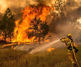 More than a dozen wildfires whipped by powerful winds swept through California wine country Monday, destroying at least 1,500 homes and businesses and sending an estimated 20,000 people on a headlong flight to safety through smoke and flames. Photo courtesy Bureau of Land Management California