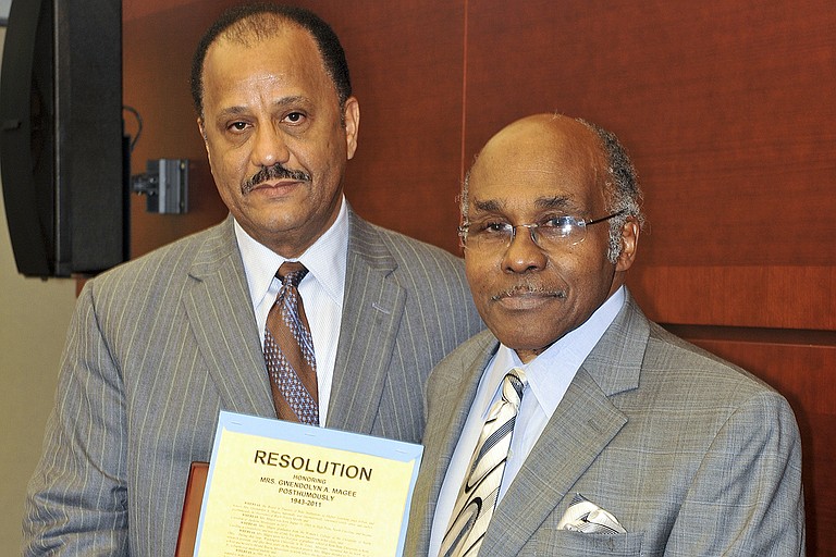 Former Trustee Bob Owens (left) presents a resolution to D.E. Magee, Jr. (right) at the 2012 Black History Month recognition ceremony in honor of the late Mrs. Magee. Photo courtesy Mississippi Institutions of Higher Learning
