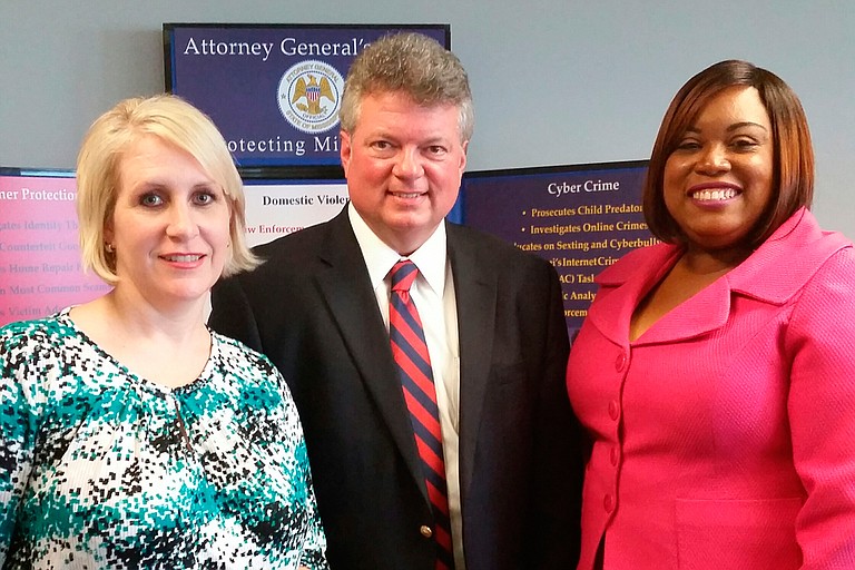 Cathy Green (left) was honored during Victims’ Rights Week in 2015 with the Image of Resilience Award, pictured here with Attorney General Jim Hood (middle) and Wendy Mahoney of the Mississippi Coalition Against Domestic Violence (right). Photo courtesy Mississippi Coalition Against Domestic Violence