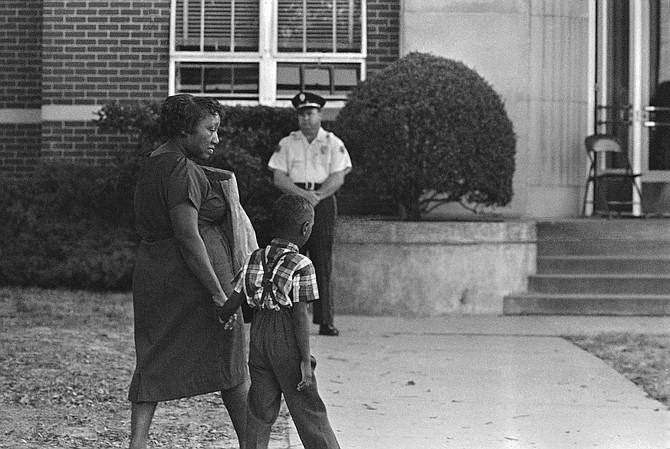 An African American first grader clutched his mother’s hand as he arrived for the first day of school at previously all-white Davis Elementary School in Jackson on Sept. 14, 1964. Black students could voluntarily integrate white schools back then, but local public schools would not fully integrate until 1970. (AP Photo)