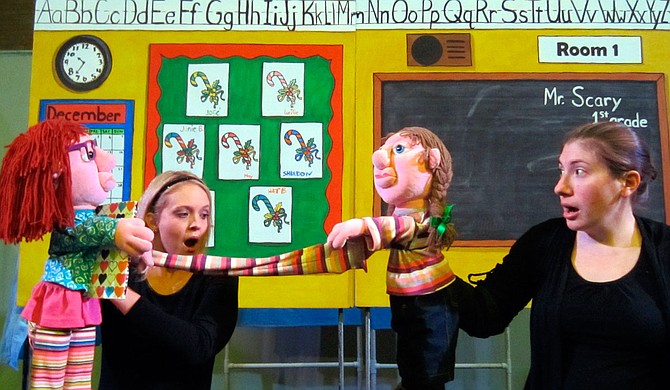 In Mississippi Puppetry Guild’s production of “Jingle Bells, Batman Smells,” Keni Bounds (left) plays the puppet version of Junie B. Jones, and Lesley Raybon (right) plays the puppet version of May. Photo courtesy Mississippi Puppetry Guild