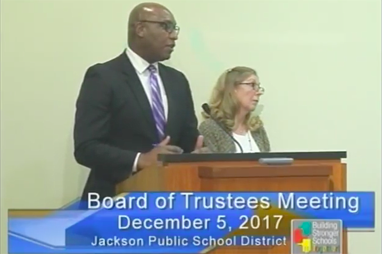 William Merritt (left) and Ann Moore (right) explain the contracts with the Bailey Group to the JPS Board of Trustees at its Dec. 5 meeting. Photo courtesy JPS TV