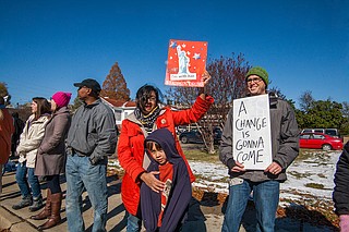 Joy Parikh (left) and Wes Harp (right) protest during the opening of the Mississippi Civil Rights Museum and Museum of Mississippi History on Saturday, Dec. 8.