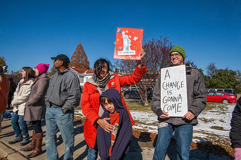 Joy Parikh (left) and Wes Harp (right) protest during the opening of the Mississippi Civil Rights Museum and Museum of Mississippi History on Saturday, Dec. 8.