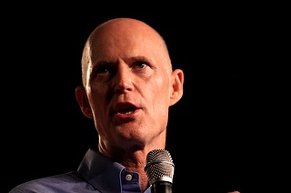 Flanked by family members of students who were killed during a mass shooting just over three weeks ago, Florida Gov. Rick Scott on Friday signed a $400 million school safety bill in response to the tragedy that killed 17 people at a high school. Photo courtesy Flickr/Gage Skidmore