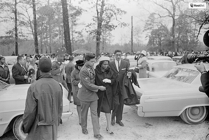 Ellie Dahmer, widow of slain civil rights leader Vernon Dahmer, being assisted to her car by family members after Dahmer's funeral on Jan. 15, 1966. Photo courtesy Wikicommons/Mississippi Department of Archives and History