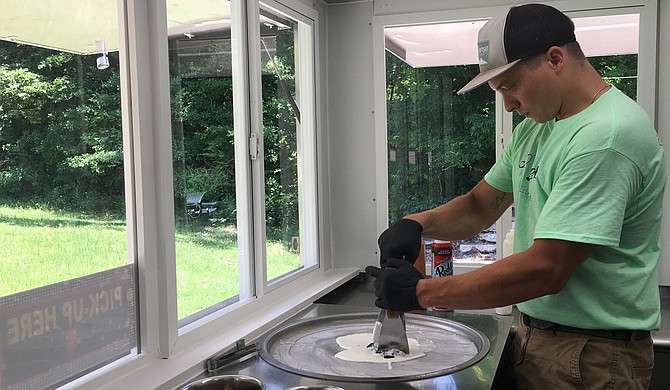 Ryan Parmentier, co-owner of 30 Below Rolled Ice Cream, chops up Oreos in the ice-cream mix for one of the business’ signature dishes, the “Cookie Jar.”