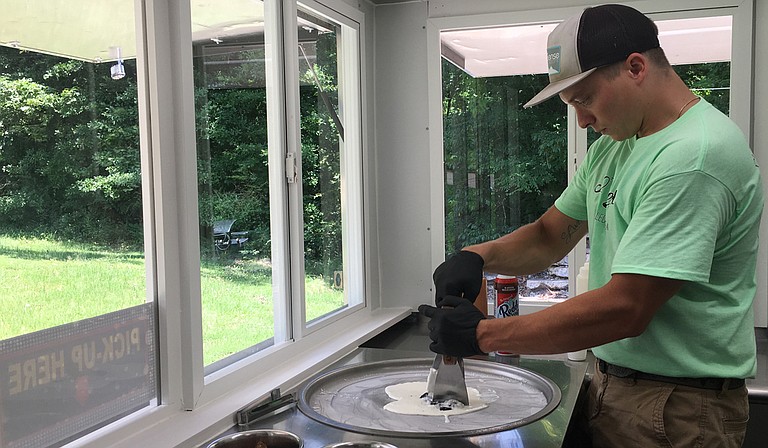 Ryan Parmentier, co-owner of 30 Below Rolled Ice Cream, chops up Oreos in the ice-cream mix for one of the business’ signature dishes, the “Cookie Jar.”