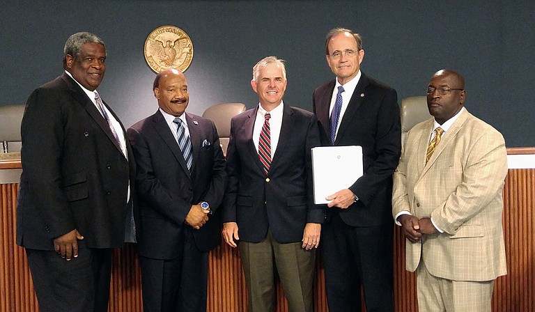 The Hinds County Board of Supervisors received a check for $42,194 from the sale of tax-forfeited property. From left to right are District 2 Supervisor Darrel McQuirter, District 1 Supervisor Robert Graham, President Mike Morgan, Secretary of State Delbert Hosemann and District 5 Supervisor Bobby McGowan.