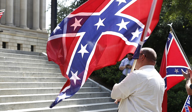 Demonstrators with the Poor People's Campaign burned a Confederate battle flag and then a separate Mississippi state flag Monday in front of the governor's mansion. Mississippi's flag has contained the Confederate battle emblem since 1894, and residents who voted in a 2001 statewide election chose to keep the emblem on it.