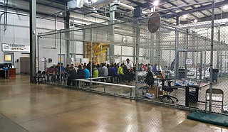 In this photo provided by U.S. Customs and Border Protection, people who've been taken into custody related to cases of illegal entry into the United States, sit in one of the cages at a facility in McAllen, Texas, Sunday, June 17, 2018.