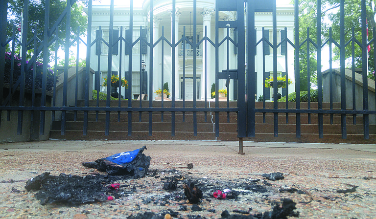 The Mississippi branch of the Poor People's Campaign burned a replica of the Confederate Flag and a Mississippi flag outside the Mississippi Governor's Mansion Monday afternoon.