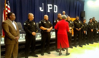 Anna Jo Bell shakes hands with Jackson police officers during the graduation ceremony for the Citizen's Police Academy on June 18.