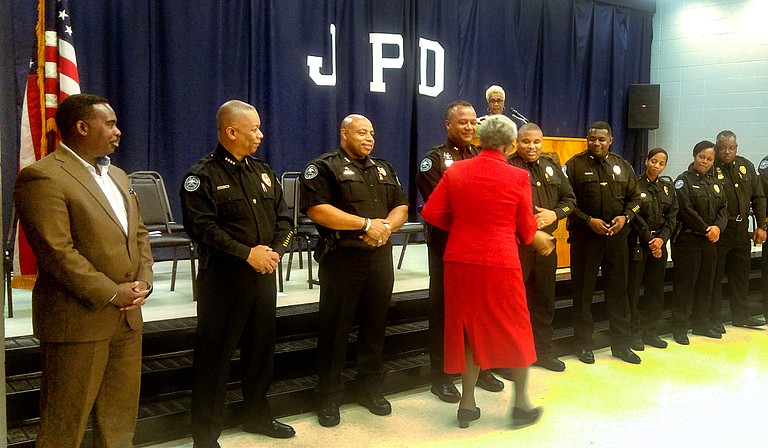 Anna Jo Bell shakes hands with Jackson police officers during the graduation ceremony for the Citizen's Police Academy on June 18.