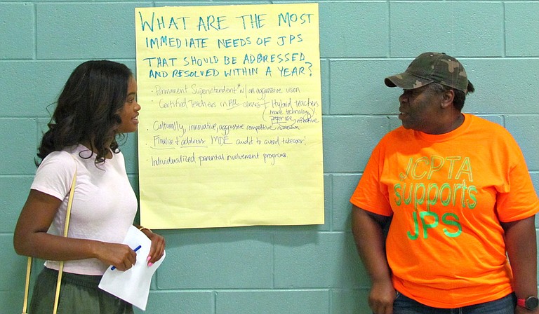 Murrah High School student Maisie Brown (left) and Michelle Henry of the Jackson Council PTA (right) talk at the People’s Assembly on Jackson Public Schools’ bond referendum on July 17.