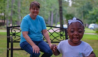 Terry Hurley, back, and her daughter Ariel Hurley, 2, play outside on July 18.