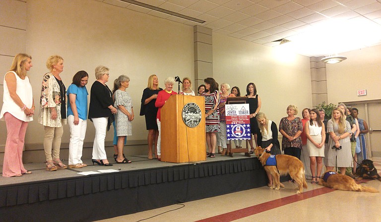 Members of the Mississippi Federation of Republican Women and the Mississippi Center for Violence Prevention stand on the stage during a press conference about human trafficking.