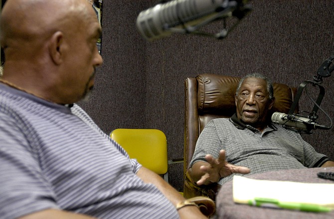 Charles Evers, right, interviews Thomas Moore, left, on his radio station in Jackson, Miss., on July 13, 2005, during a journey back to Mississippi to seek justice for the Ku Klux Klan murders in 1964 of his younger brother, Charles Moore, and his friend, Henry Dee.  James Ford Seale died in prison after the journey, accompanied by the Jackson Free Press, inspired a federal trial. Evers is the brother of slain civil-rights leader Medgar Evers. Photo by Kate Medley