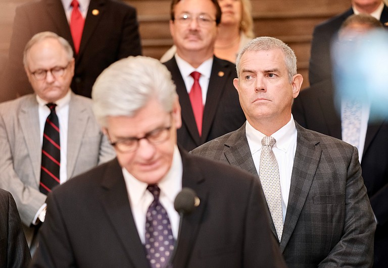 Mississippi House Speaker Philip Gunn, R-Clinton, right, attends a press conference in Jackson on Aug. 23, 2018, as Gov. Phil Bryant speaks in support of a bill to create a state lottery. Gunn chose not to block a vote on the lottery, despite personal opposition to the creation of one. Photo by Ashton Pittman