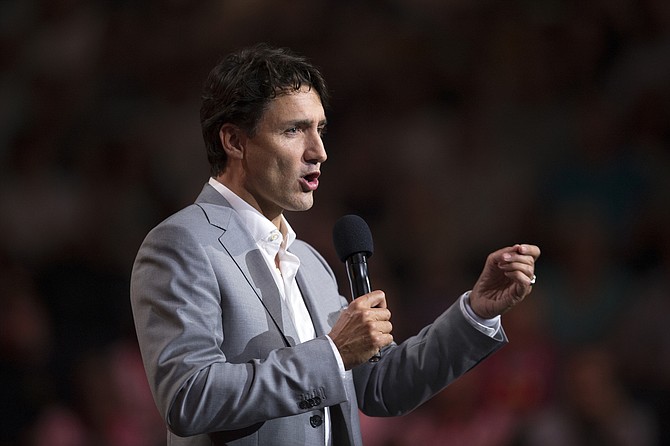 Trump put pressure on Canada and Canadian Prime Minister Justin Trudeau (pictured) by threatening to tax Canadian auto imports and to leave Canada out of a new regional trade bloc.