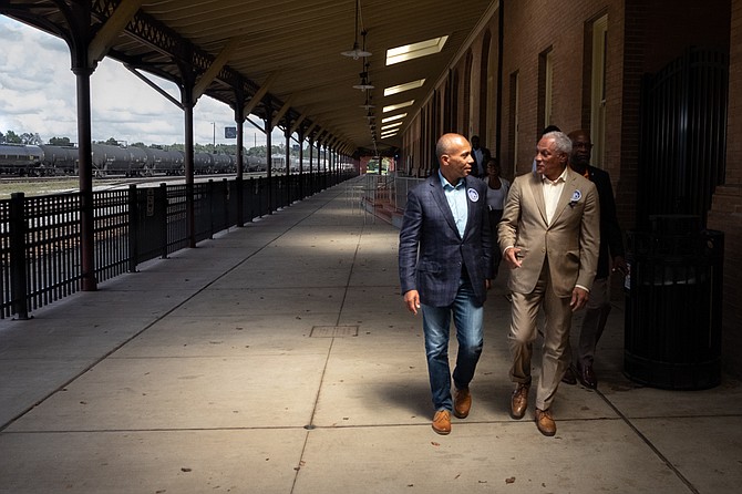 Former Massachusetts Gov. Deval Patrick speaks with Mike Espy, a Democrat running in Mississippi's U.S. Senate special election, at the train station in Hattiesburg, Miss., just after announcing his support on Sept. 22, 2018. Photo by Ashton Pittman