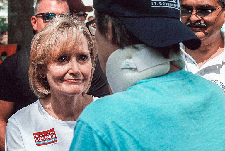 U.S. Sen. Cindy Hyde-Smith, R-Miss., listens to a constituent's health-care concerns at the Neshoba County Fair on Aug. 2, 2018. On Oct. 10, she voted to allow the expansion of plans that can deny pre-existing conditions coverage.