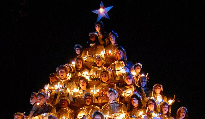 Today, the Singing Christmas Tree features a 35-foot-tall wooden and metal tree structure that holds up to 100 singers, including members of the Belhaven Concert Choir, alumni, faculty and staff. The singers now wear white robes with reflective collars and tiaras, in addition to holding lights. Photo courtesy Belhaven University