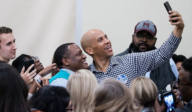 U.S. Sen. Cory Booker takes selfies with college students at the University of Southern Mississippi, where he campaigned for Democratic U.S. Senate candidate Mike Espy on Nov. 19. Photo by William Pittman