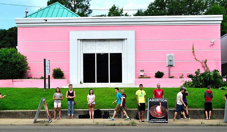A lawsuit fighting Mississippi's 15-week abortion ban on behalf of Jackson Women's Health Organization, known as the Pink House, will move on to the 5th U.S. Circuit Court of Appeals. This photo is from a 2014 protest outside the clinic. Trip Burns/File Photo