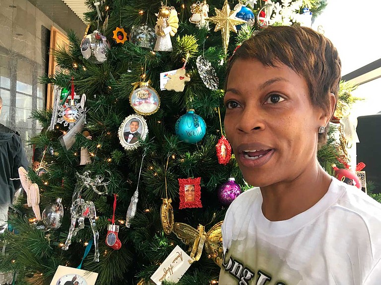 Lisa Donegan of Arlington, Texas, shows an ornament with a photo of her son, 21-year-old Tray Williams, on a Christmas tree honoring Mississippi crime victims. A hit-and-run driver killed Williams in 2014 in northern Mississippi’s Pontotoc County. Photo courtesy Emily Wagster Pettus/AP