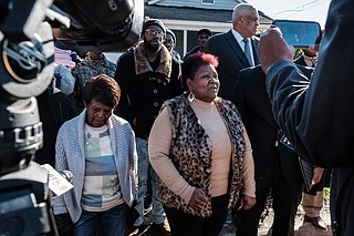 Bettersten Wade, the sister of George Robinson, demands "justice" at a press conference at the site where her brother's encounter with police began. Next to her is his mother, Vernice Robinson.