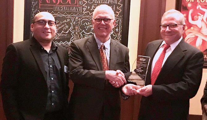 On Jan. 31, the Jackson chapter of technology organization CompTIA Association of Information Technology Professionals named Richard Sun (middle) as Mississippian of the Year. He says the award represents the collective achievement of everyone who is involved in the Mississippi Coding Academies. He is pictured with MSCA instructor Javier Peraza (left) and AITP President Bart Uharriet (right). Photo courtesy Mississippi Coding Academies
