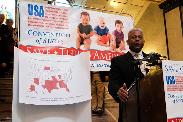 Retired U.S. Army Lt. Col. Allen West speaks in the Mississippi Capitol rotunda to support a resolution for a new constitutional convention. A map behind him shows the state legislatures that have already passed resolutions.