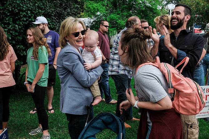 U.S. Sen. Cindy Hyde-Smith holds a baby at a campaign event in Clinton, Miss., on Oct. 13, 2018.