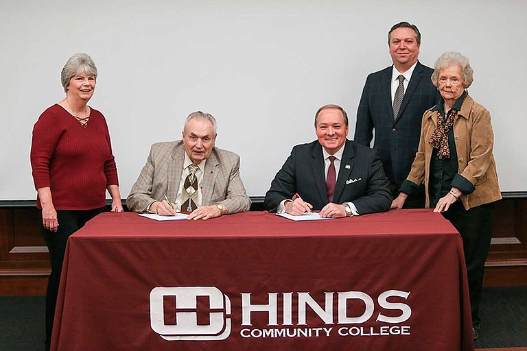 Hinds Community College President Clyde Muse (center left) and Mississippi State University President Mark E. Keenum (center right) signed an agreement formalizing Hinds’ new membership with the Mississippi Library Partnership on Wednesday, March 20. Others in the photo are Hinds Community College District Dean of Libraries Mary Beth Applin (left), MSU Associate Dean of Libraries Stephen Cunetto (back right) and MSU Dean of Libraries Frances Coleman (right). Photo by April Garon