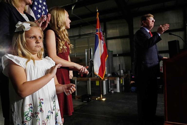 Maddie Reeves, 7, left, the youngest daughter of Lt. Gov. Tate Reeves, applauds during her father's speech during the kickoff event for his race for governor, Monday, April 8, 2019, in Pearl, Miss. Photo by Rogelio V. Solis via AP